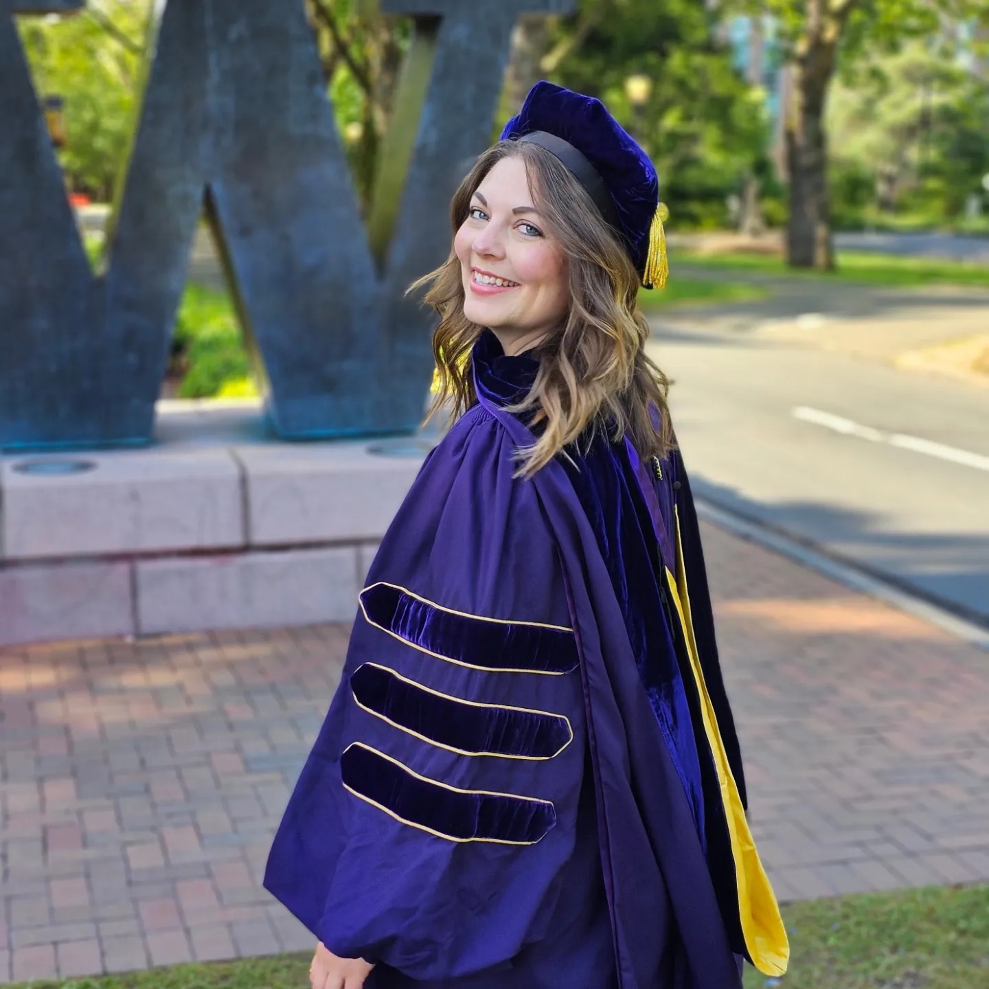 Doll in graduation regalia during 2024 UW commencement week.